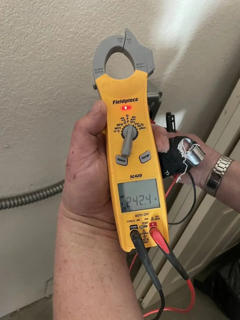 Voltage testing with clamp meter during Ceiling Fan Installation in Decatur